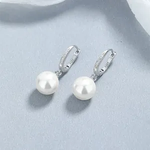 Detail shot of 925 sterling silver stamp on pearl earrings with sparkling zircons
