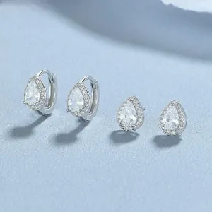 Macro detail of pear-cut cubic zirconia stud and hoop earrings set in 925 sterling silver