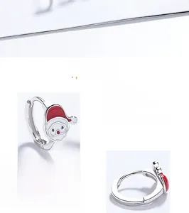 Detailed macro view of 925 silver Christmas Santa earrings with red enamel finish