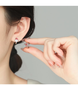 Detail of 925 silver asymmetric Christmas earrings with Santa and tree charms