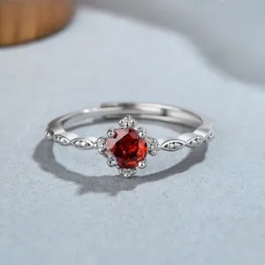 Macro detail of 925 sterling silver ring with red zircon in four-prong vintage setting