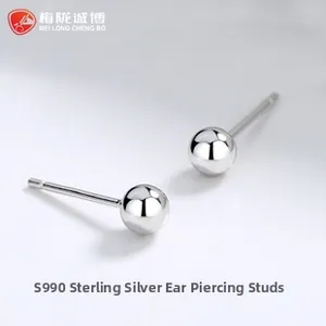 Close-up of S990 sterling silver ball stud earrings with polished mirror finish