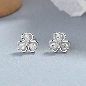 Detailed macro view of 925 silver clover earrings with sparkling teardrop zircons