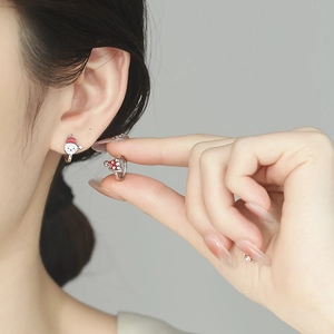 925 silver Christmas earrings featuring Santa Claus and hat design on model ear