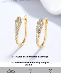 Macro shot of S925 sterling silver stamp on gold U-shaped earrings with zircon pavé