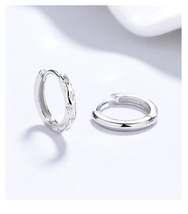 Detailed macro view of S925 sterling silver star hoop earrings with zircon accents