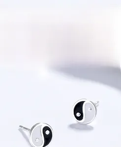 Detail of S999 silver Tai Chi stud earrings featuring black and white enamel finish