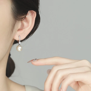 French style 925 silver pearl drop earrings with sparkling cubic zirconia on model