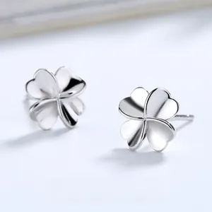 Macro shot of 925 sterling silver four-leaf clover earrings with polished metal finish