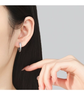 Close-up of S925 sterling silver U-shaped earrings with zircons on model ear