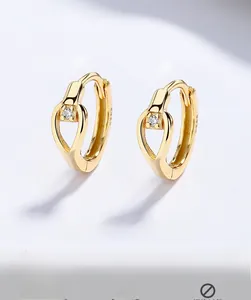Macro shot of 925 silver gold drop earrings showing S925 hallmark and zircon stone detail
