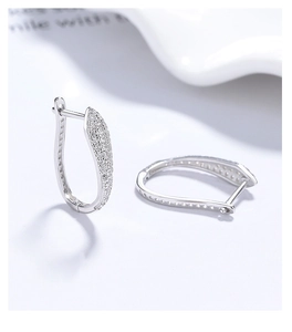 Macro shot of 925 silver U-shaped hoop earrings with sparkling pavé zircon setting