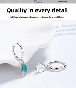 Detail of S925 sterling silver hoop earrings with oval green stone and bead trim