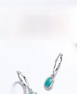 Detail of S925 silver hoop earrings with oval turquoise pendant and thick plating