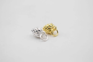 Detailed close-up of S925 sterling silver and gold pine cone pendants for jewelry making