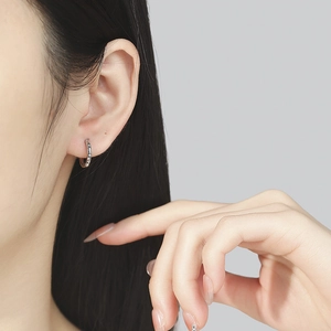 925 silver star hoop earrings with sparkling cubic zirconia on a model's ear