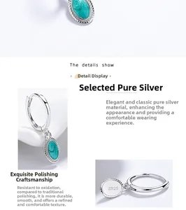 Detail view of 925 sterling silver hoop earrings with green oval enamel pendants