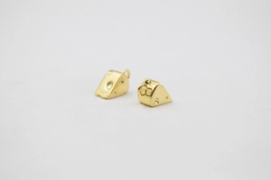 Macro detail of S925 sterling silver stamp on small golden cheese cake charm