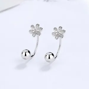 Detailed macro view of S925 sterling silver daisy earrings with sparkling zircon crystals