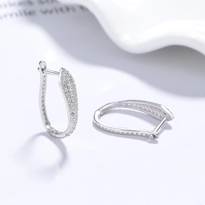 925 silver S-shaped hoop earrings with pave-set sparkling zircon stones on white tray