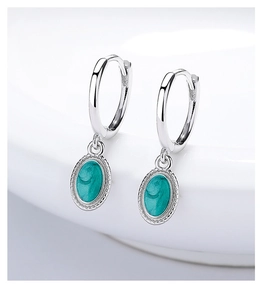 Detailed close-up of 925 silver hoop earrings with oval turquoise enamel pendants and milgrain edges