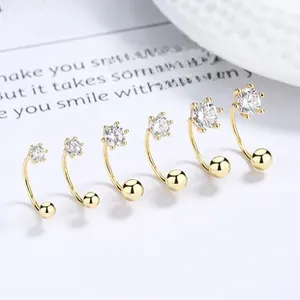 Detail of 925 sterling silver gold-plated C-shaped stud earrings in six graduated sizes