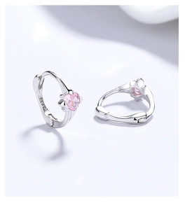 Detail view of S925 sterling silver heart earrings with pink zircon and hallmark