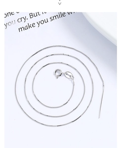 Macro detail of S925 sterling silver box chain with adjustable needle and spring clasp