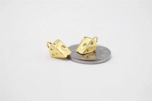 Macro shot of S925 sterling silver gold-plated cheese charms next to a coin for size