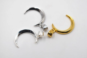 Detailed view of S925 sterling silver moon pendants with hallmark and polished finish