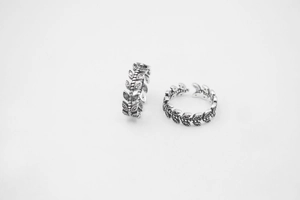 Macro shot of vintage S925 sterling silver leaf rings with detailed antique finish textures