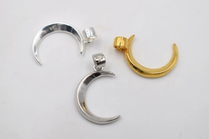 Macro detail of S925 sterling silver and gold-plated moon crescent pendants