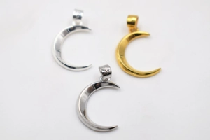Detailed view of S925 sterling silver moon pendants in silver, gold and black finishes