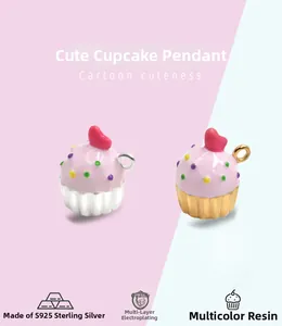 Detail of S925 sterling silver cupcake pendants with pink enamel and red heart decoration
