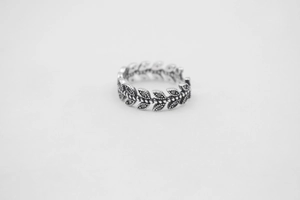 Macro detail of vintage S925 sterling silver leaf ring with black zircon inlays