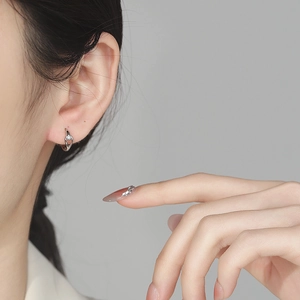 Elegant 925 sterling silver hollow teardrop hoop earrings with zircon on a female model