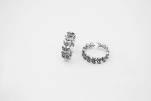Detail of vintage S925 sterling silver leaf rings with retro oxidized finish and open band