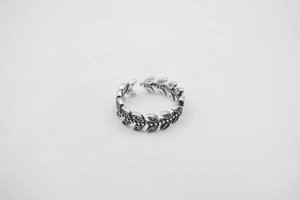 Detail of vintage S925 sterling silver leaf ring with oxidized finish and micro zircon stones