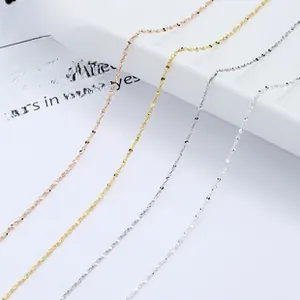 Macro shot of 925 sterling silver water wave chains in gold, rose gold and silver finishes