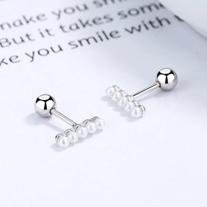 Detail of 925 silver horizontal bar stud earrings with five small pearls and ball backs