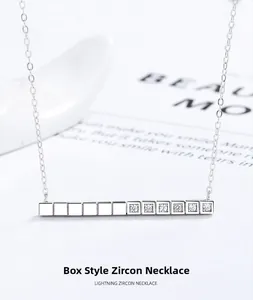 Detailed macro view of silver bar necklace featuring square modules and white zircons