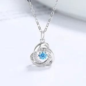 Macro shot of S925 silver necklace with dancing blue gemstone pendant and crystals