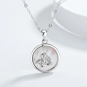 Detailed close-up of a 925 sterling silver cherub pendant with a shimmering shell base