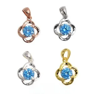 Detail of four-petal hollow flower pendants in 925 silver with blue round gemstones