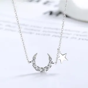 Detailed macro shot of S925 sterling silver moon and star necklace with cubic zirconia