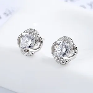 Detailed view of silver four-leaf clover earrings with sparkling round zircon center