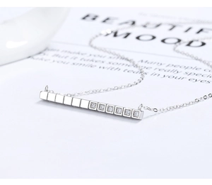 Detailed close-up of a 925 silver linear pendant with inlaid zircon on a dainty chain