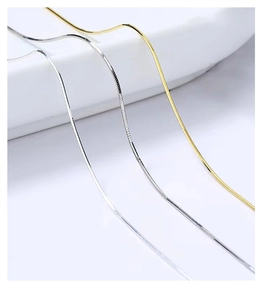 Macro detail of fine S925 sterling silver snake chain in gold and silver finish