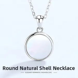 Detailed close-up of a circular natural shell pendant on a 925 silver link chain
