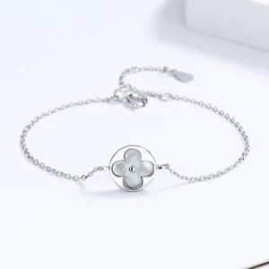 Macro shot of 925 silver bracelet featuring a white mother-of-pearl clover pendant